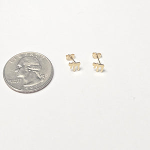 Chai 14k earrings next to quarter for scale